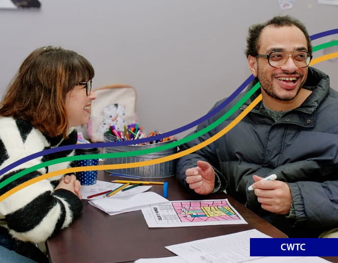 Man coloring with woman smiling at him